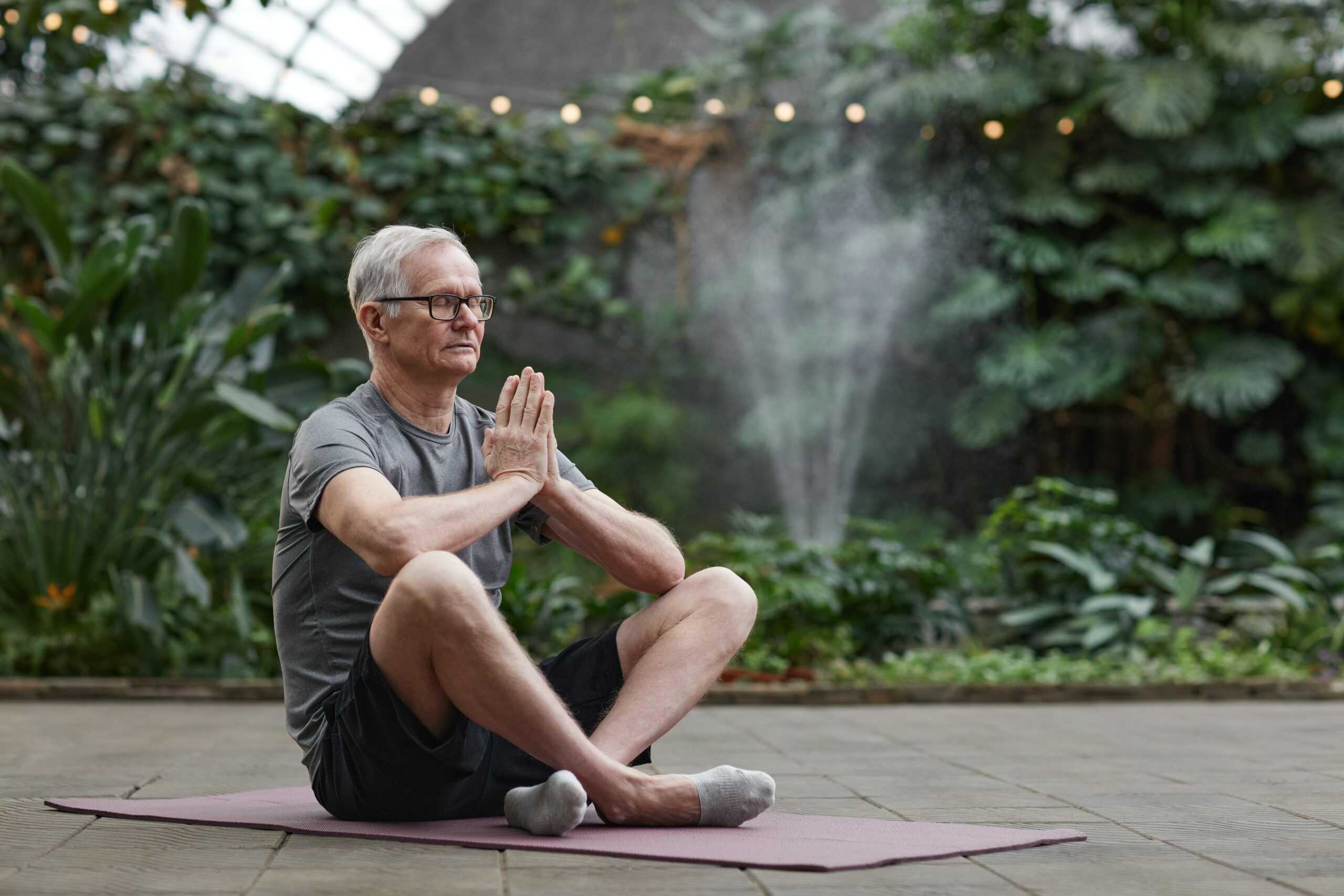 senior man meditating outdoors