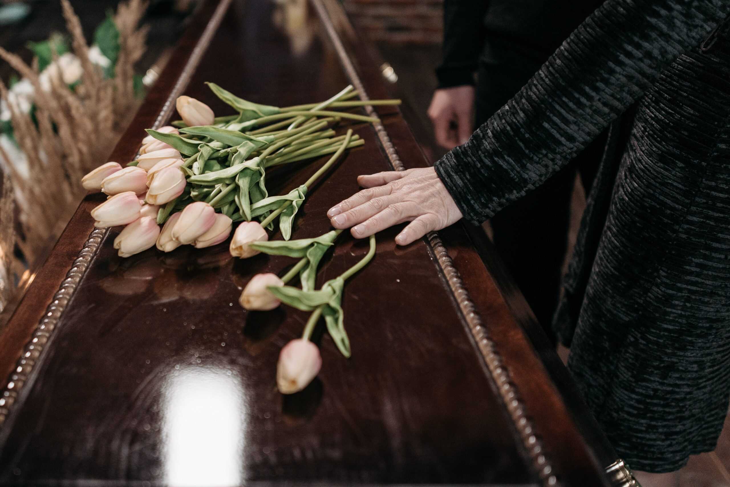 flowers laying on a casket
