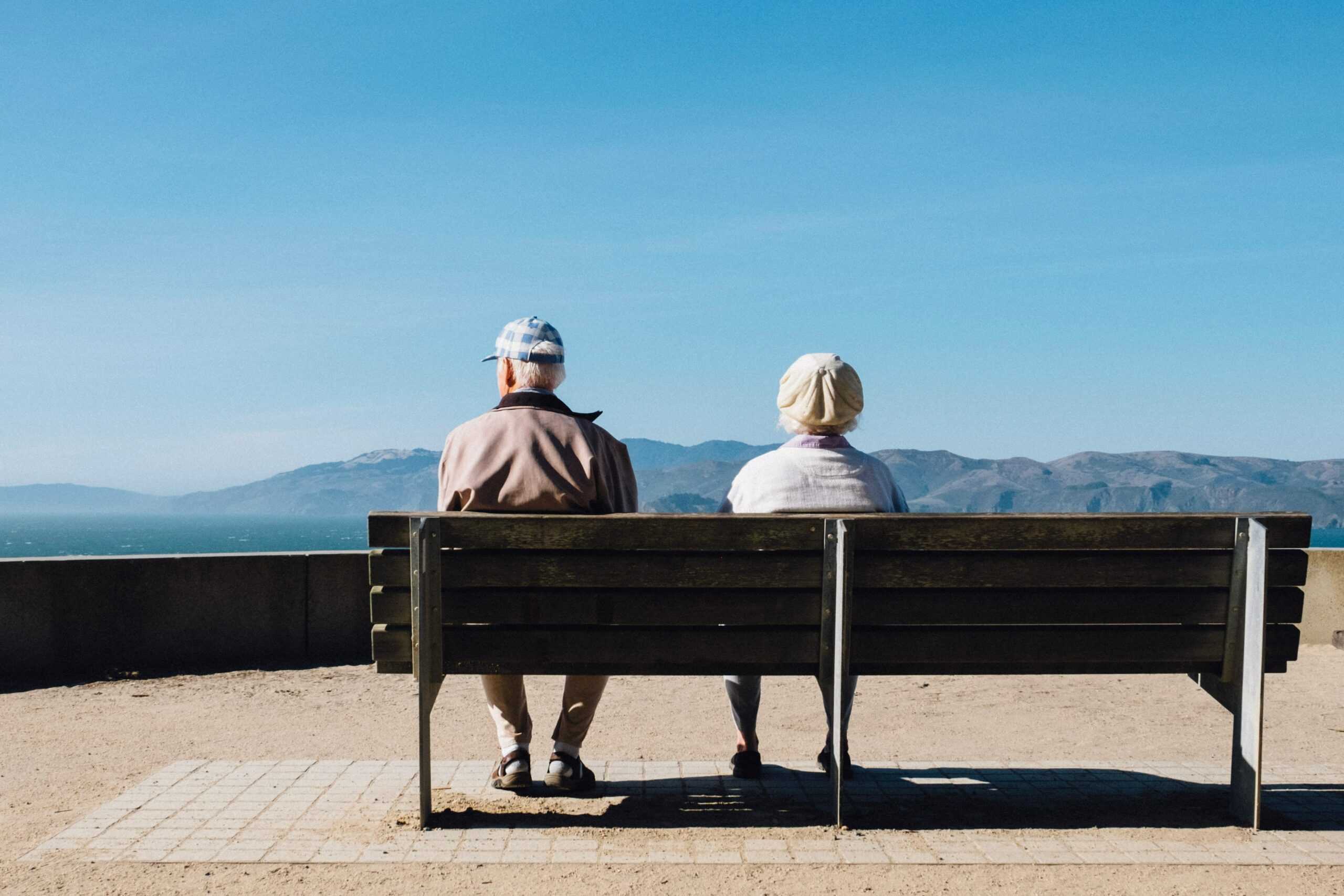 Two seniors sitting on a bench