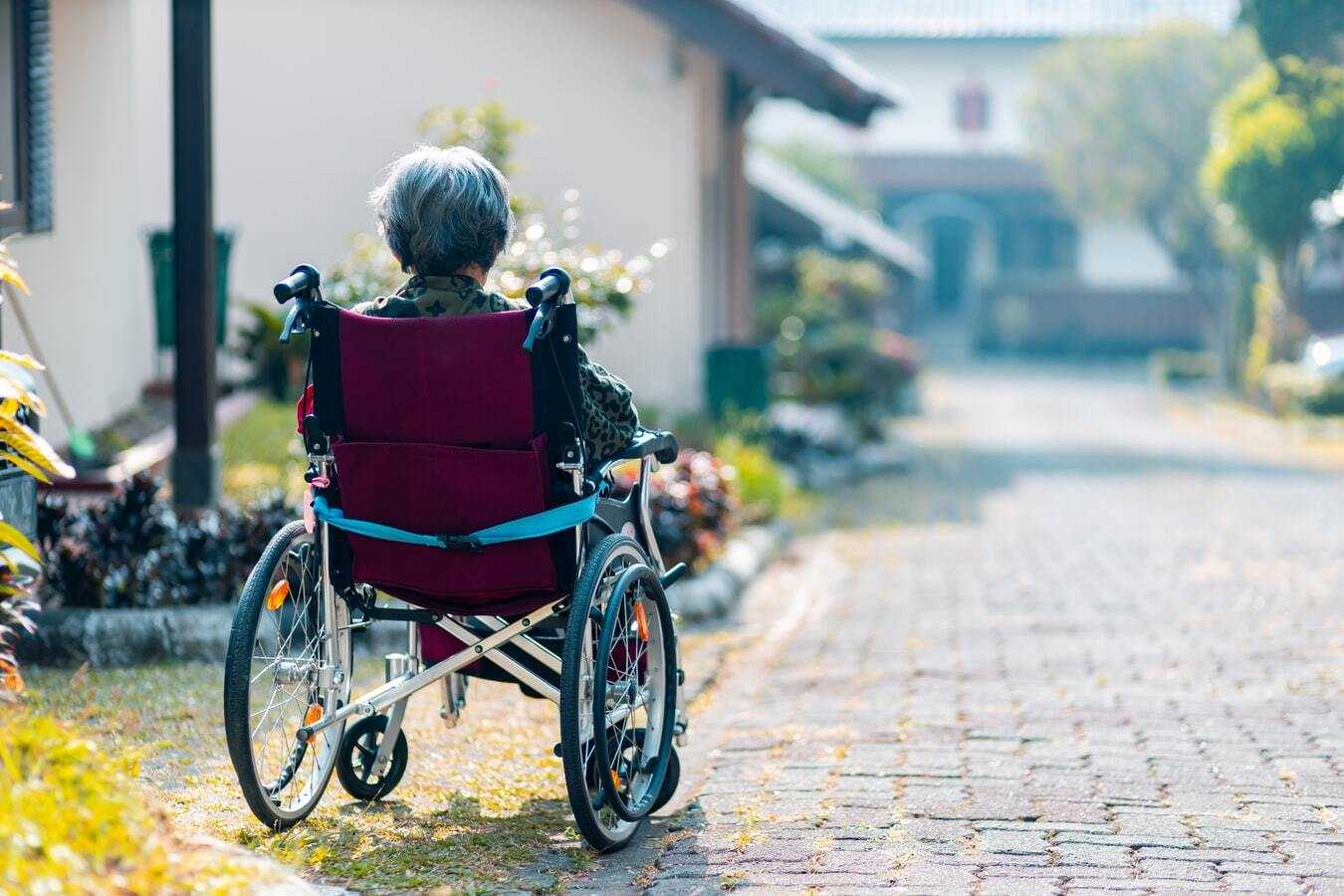 Senior woman sitting in a wheelchair outside
