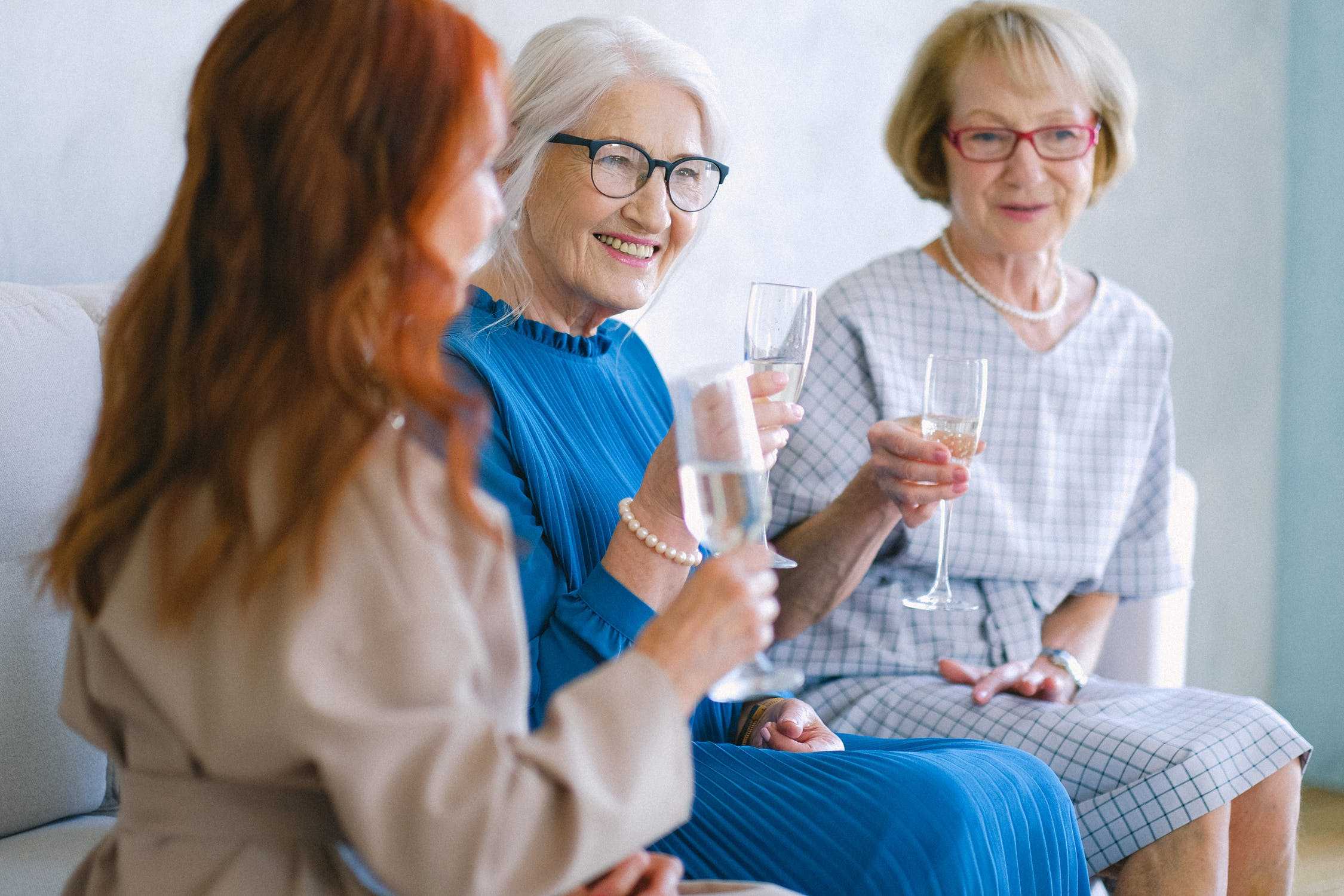 Three seniors drinking wine together