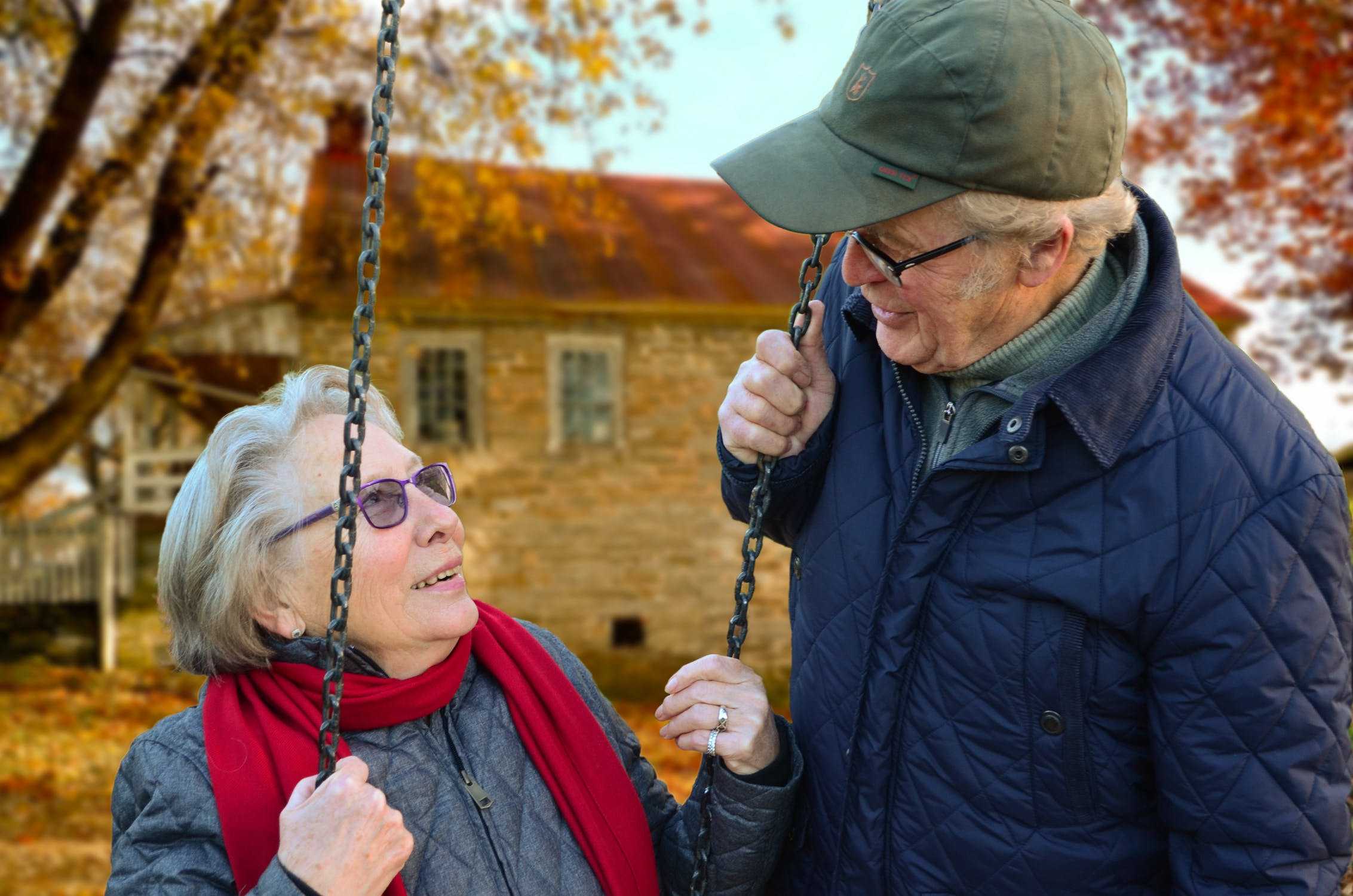 Senior man talking to his wife on a swing