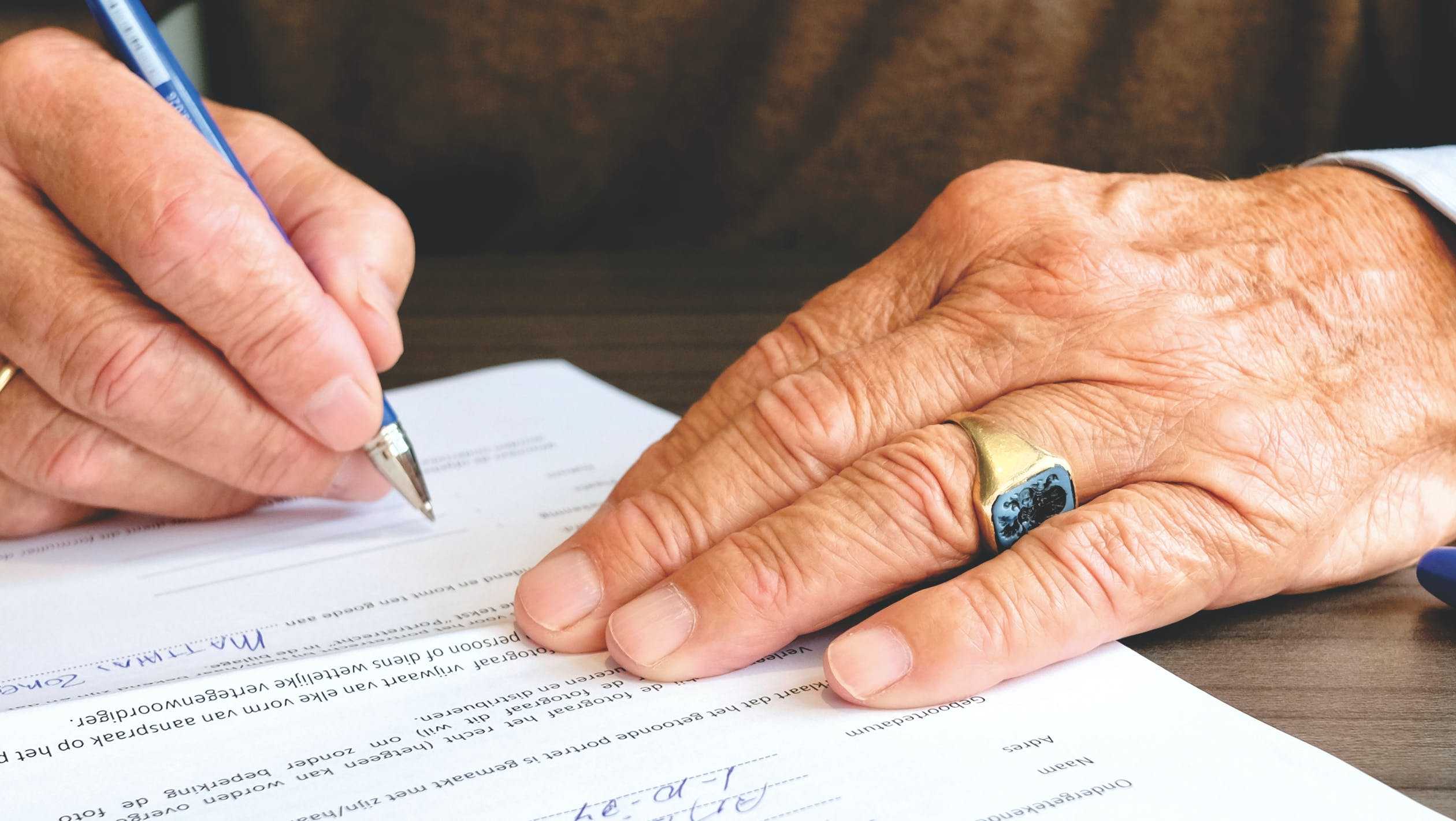 Senior man signing paperwork