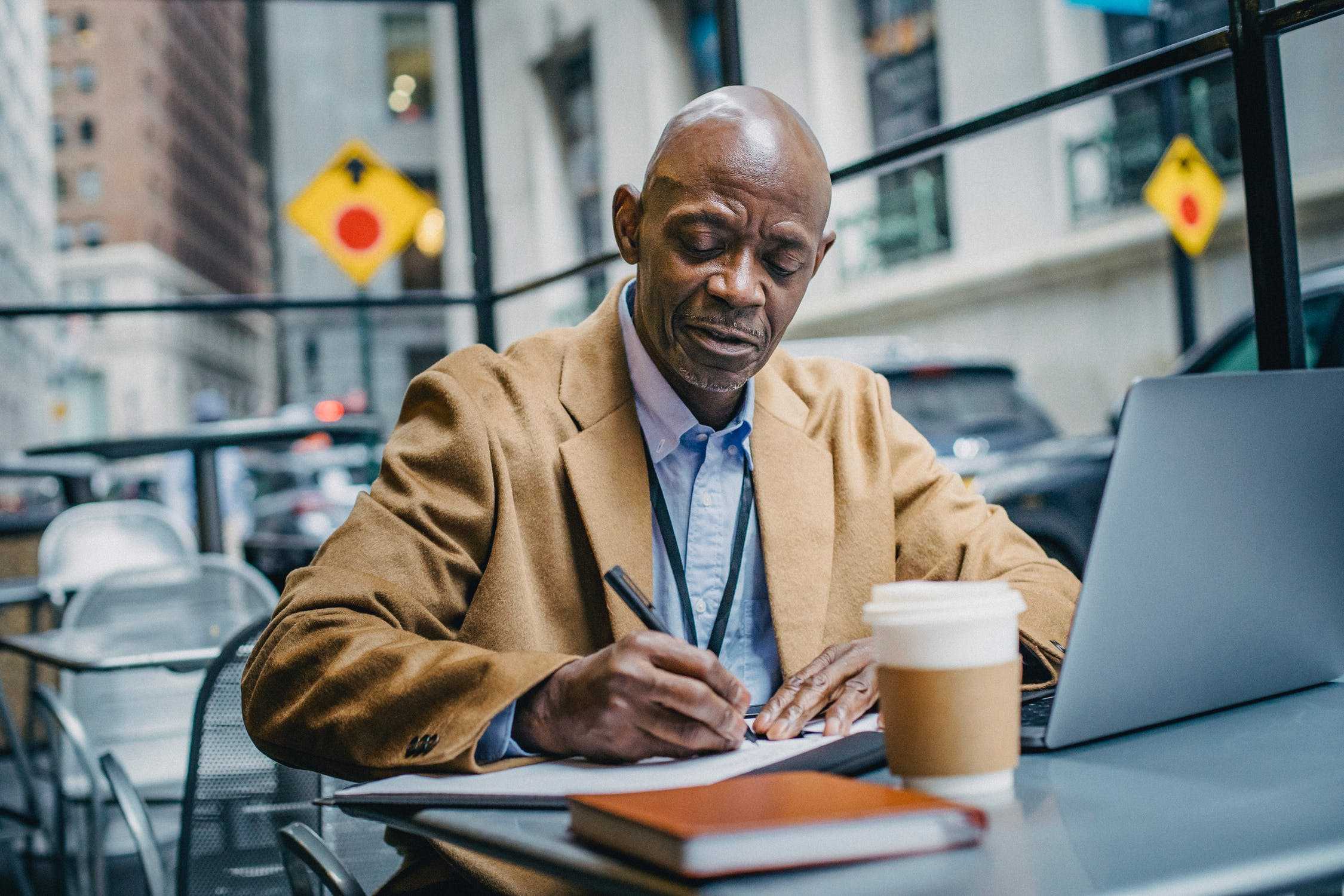 Senior man writing on a notebook
